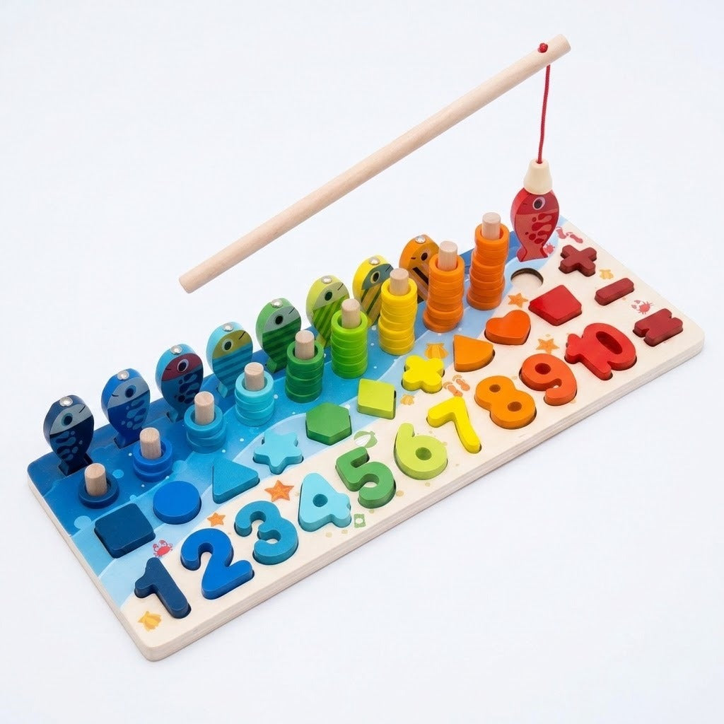 A wooden rod suspends a red fish above a colorful activity board with stacking rings, shapes, and numbers against white.