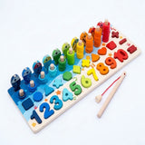 Wooden activity board with rainbow fish, counting rings, shapes, numbers, and a red-cord fishing rod on a white background.