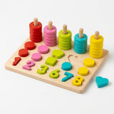 Wooden activity board with colorful ring stacks, shapes, and numbers, with a turquoise heart beside its empty slot on a white background.