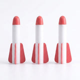 Three white foam rockets for a rocket launcher toy stand against a white background, each with a rounded red tip and red fins.