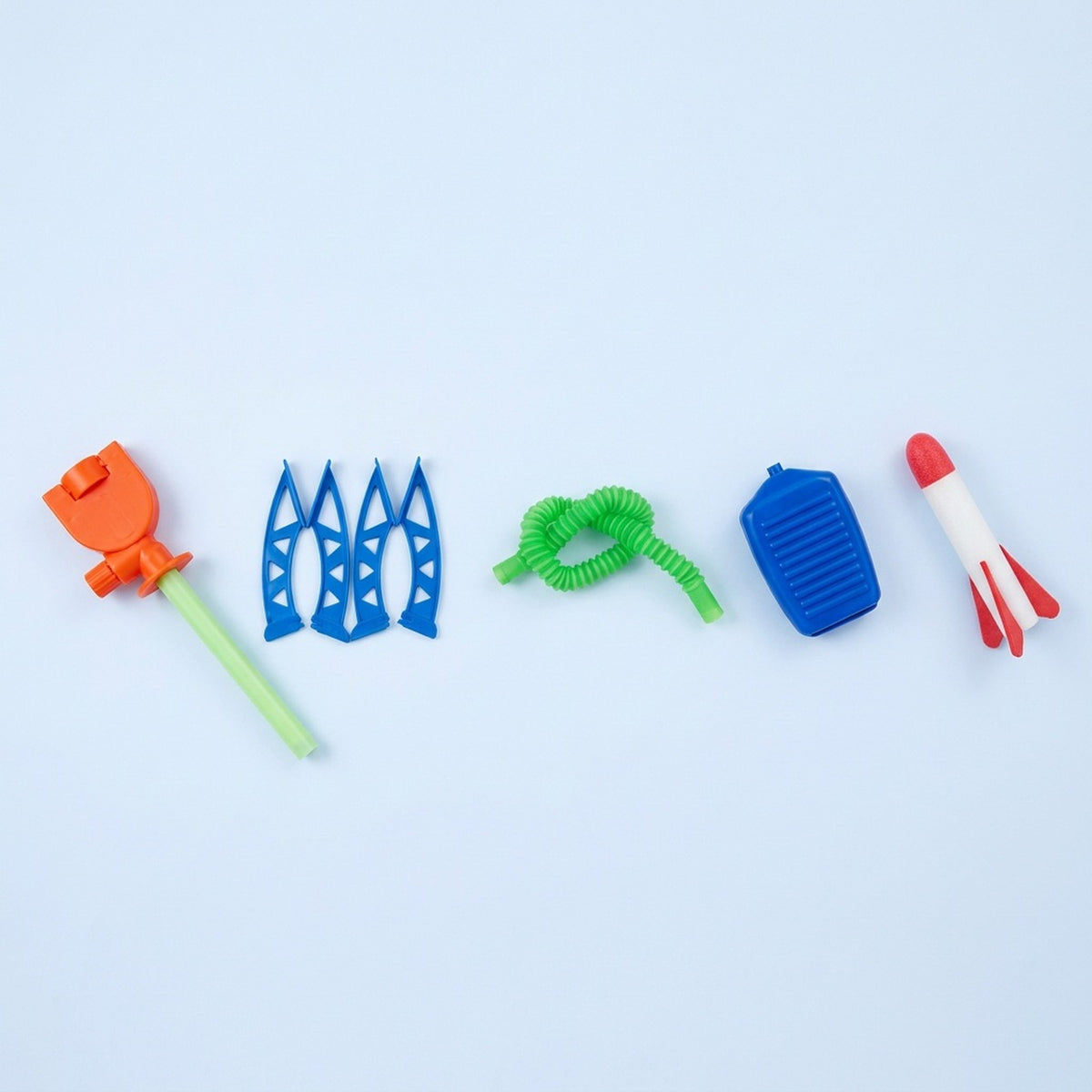 Disassembled launcher-and-1-rocket set of a rocket launcher toy laid out on a pale background, including blue legs, green hose, blue pump, and one red-and-white foam rocket.