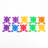 Ten plastic jumping frog toys in purple, yellow, green, orange, blue and red form two rows on a white background.