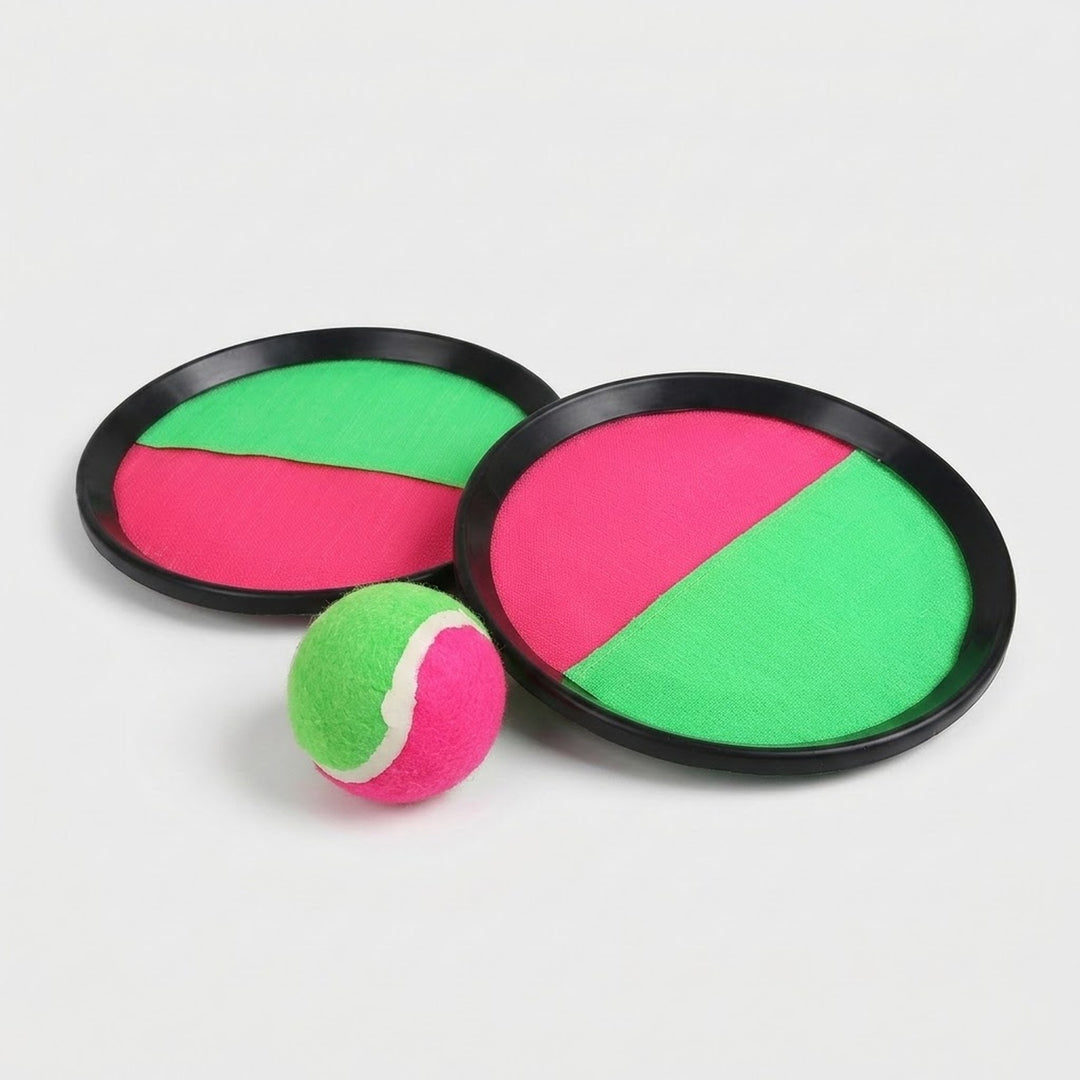 Catch game set with two black-rimmed paddles featuring pink and green cloth faces, with a matching ball in front on light gray.