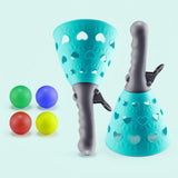 Catch game set with two turquoise plastic basket launchers, gray handles, heart cutouts, and four colorful balls on a pale mint background.
