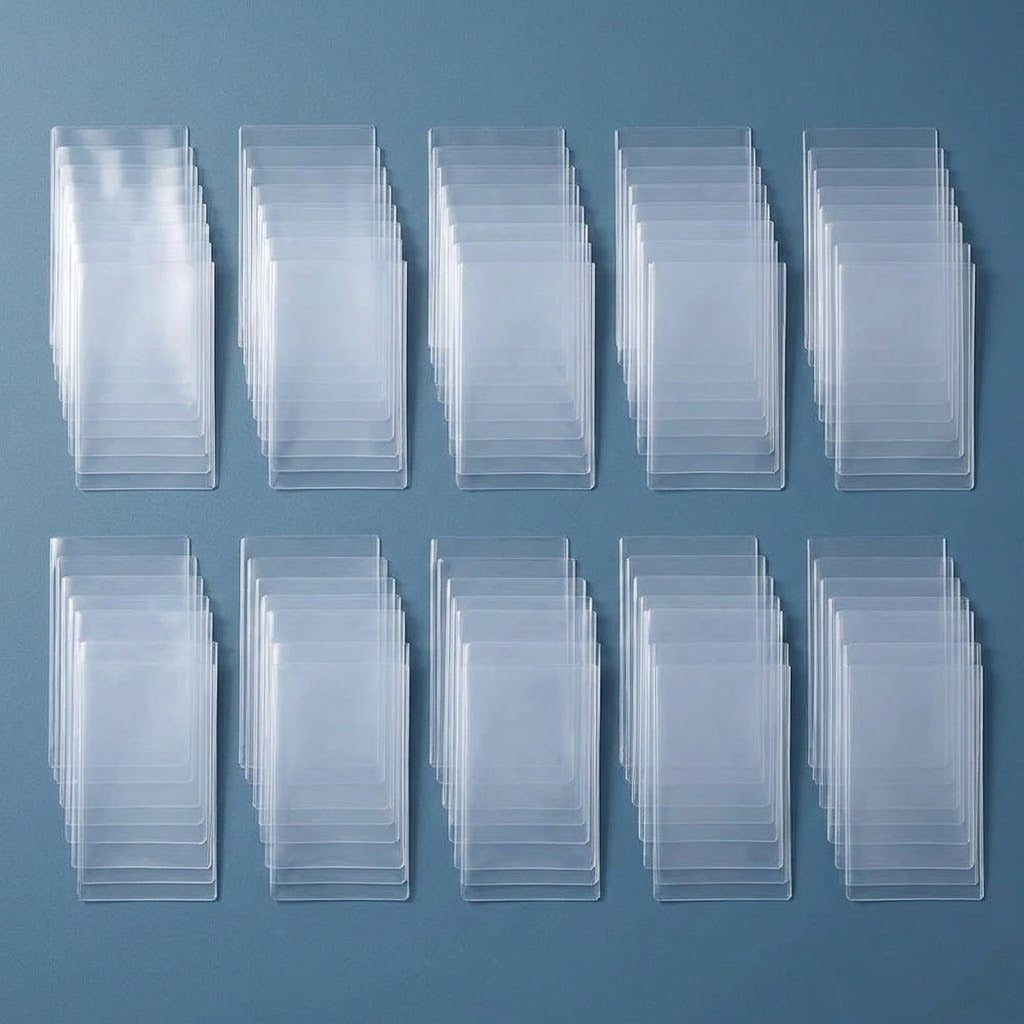 Ten overlapping groups of empty clear plastic card sleeves are arranged in two rows on a blue surface.