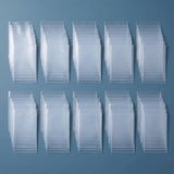 Ten overlapping groups of empty clear plastic card sleeves are arranged in two rows on a blue surface.