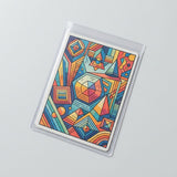 A clear plastic sleeve holds a colorful geometric card, resting diagonally on a light gray surface.