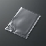 A clear plastic card sleeve lies diagonally on a charcoal surface, with wrinkles near one lower corner.