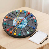 Black circular rope puzzle with tangled colorful ropes and a white drawstring bag beside it on a light wooden table.
