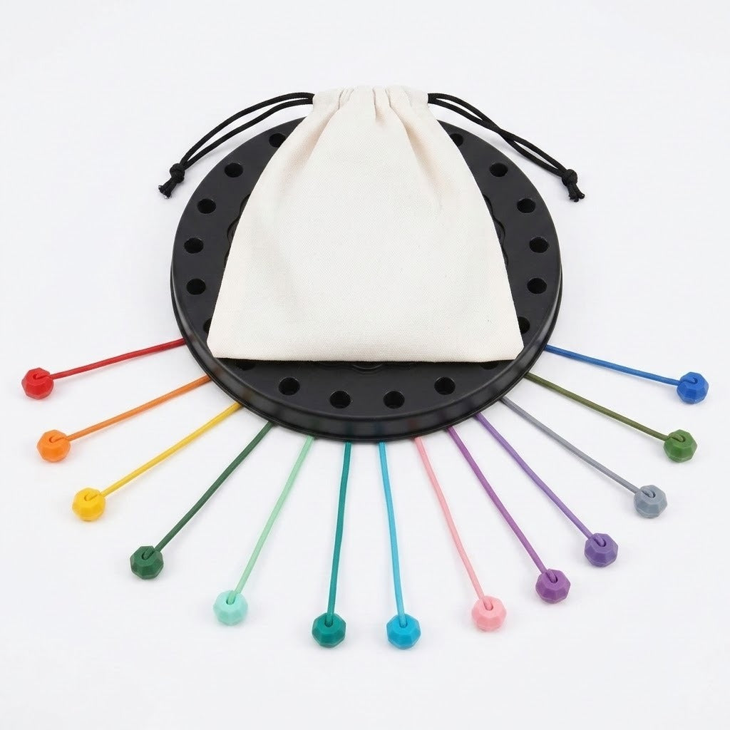 Rope puzzle with a white drawstring bag covering the black board and colorful ropes fanned outward against a white background.