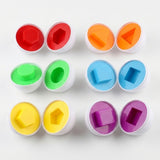 Matching egg set with six opened white eggs displaying colorful raised shapes and recesses arranged on a white background.