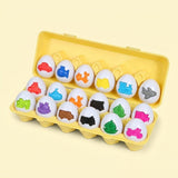 Matching egg set with white shells and colorful vehicle shapes sits in an open yellow case against a pale yellow background.