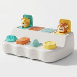 White pop-up toy with giraffe and lion raised, two lids closed, and four colorful controls against a white background.