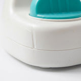 Close-up of the pop-up toy showing its rounded white base, body seam, and teal control against a white background.