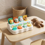 Pop-up toy with giraffe, elephant, rabbit and hedgehog figures raised, on a light wood table next to a brown teddy bear.