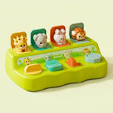 Bright green pop-up toy with giraffe, elephant, rabbit and lion figures popped up on colored flaps, against a plain pale background.