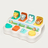 A colorful baby toy piano with animal pop-up buttons and touch keys, photographed on a clean light gray background.