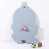 Sticky ball target showing its plain pale blue reverse on a white background, with one ball attached and two below.