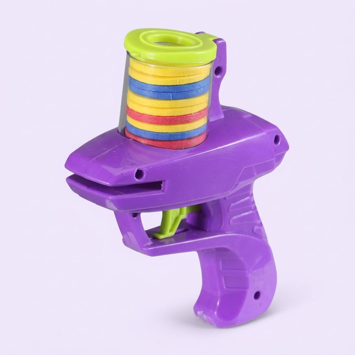 A purple plastic disc shooter with lime green accents and stacked yellow, blue, and red discs stands against a pale lavender background.