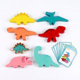 Colorful wooden dinosaur stacking blocks lie on a white background beside illustrated cards and a smaller green dinosaur piece.