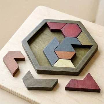 A wooden tangram puzzle set arranged on a hexagonal tray, with several loose geometric pieces placed around it on a light wood surface.