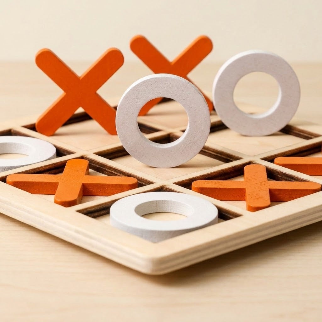 A wooden tic-tac-toe game board with orange X-shaped pieces and white O-rings on a light wood surface.