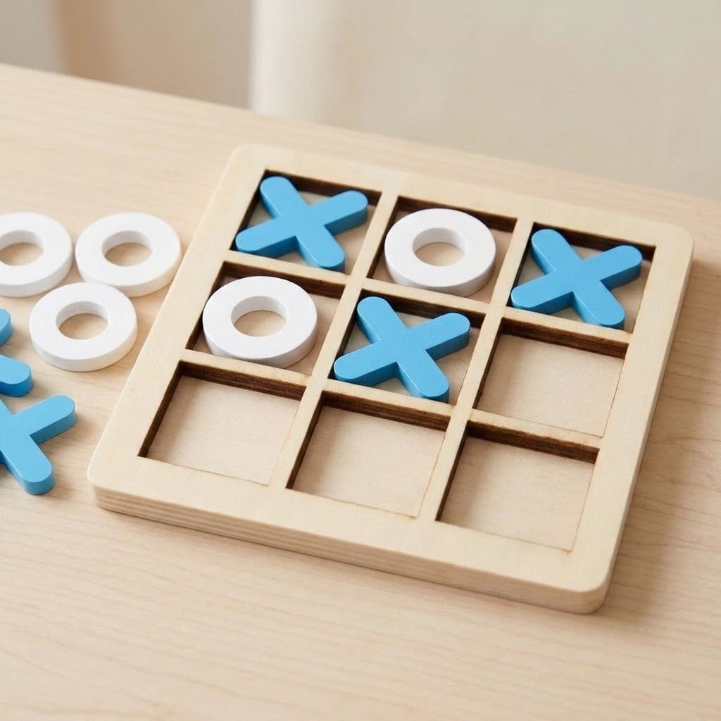 A wooden 3-in-1 tic-tac-toe game board with blue X-shaped pieces, white O-shaped pieces, and loose white and blue discs on a light wood tabletop.