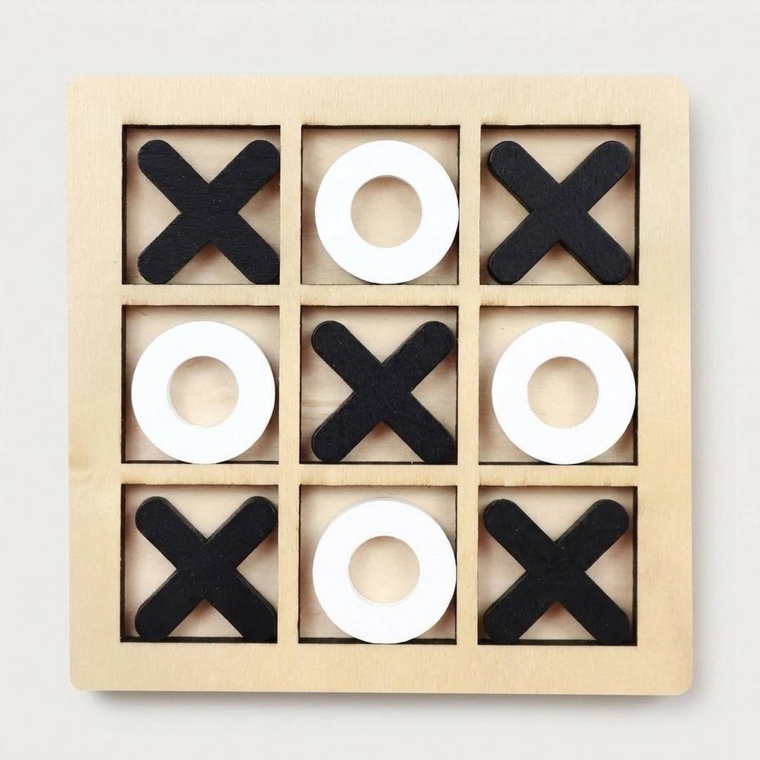 A wooden 3x3 tic-tac-toe game board with black X shapes and white O shapes arranged on a light natural wood frame, photographed from above on a plain light background.