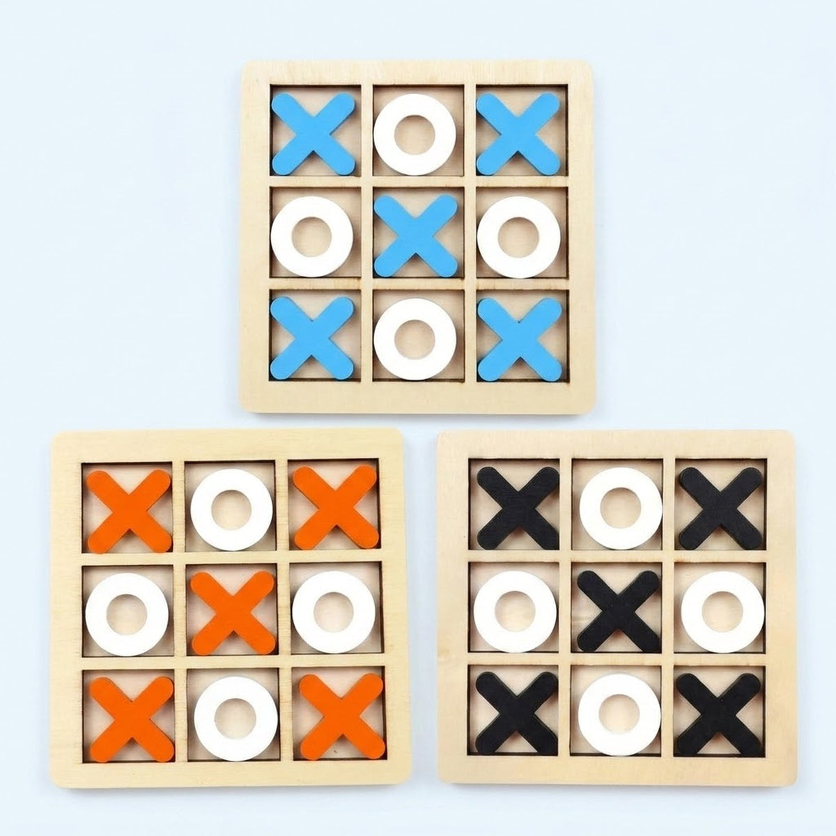 Three wooden 3x3 tic-tac-toe games shown on a light blue background, each with a natural wood frame and alternating blue, white, and orange or black shapes.