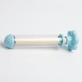 A light blue water gun with a clear barrel and cream inner shaft lies horizontally against a white background.