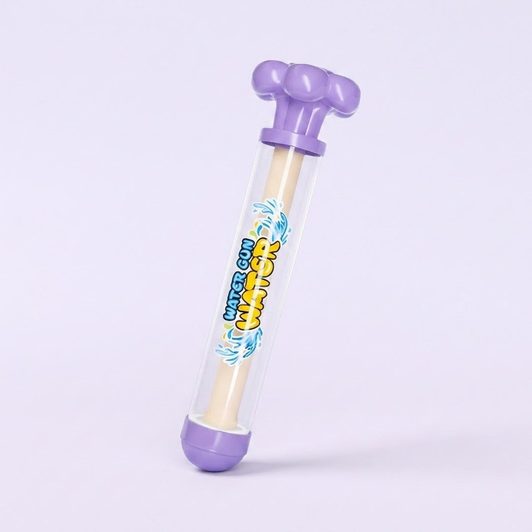 A plastic water gun toy with a clear cylindrical body, purple top and bottom caps, and a beige foam-like inner rod. The body has colorful printed graphics with the text 'water gun'.