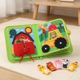 Green fabric busy book opens to barn and tractor activities on a cream floor mat, with animal finger puppets arranged in front.