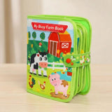 A children's zippered activity book titled 'My Busy Farm Book' with colorful cartoon farm illustrations including a cow, pig, chicken, barn, and duck. The book is standing upright on a light wood surface against a soft beige background.