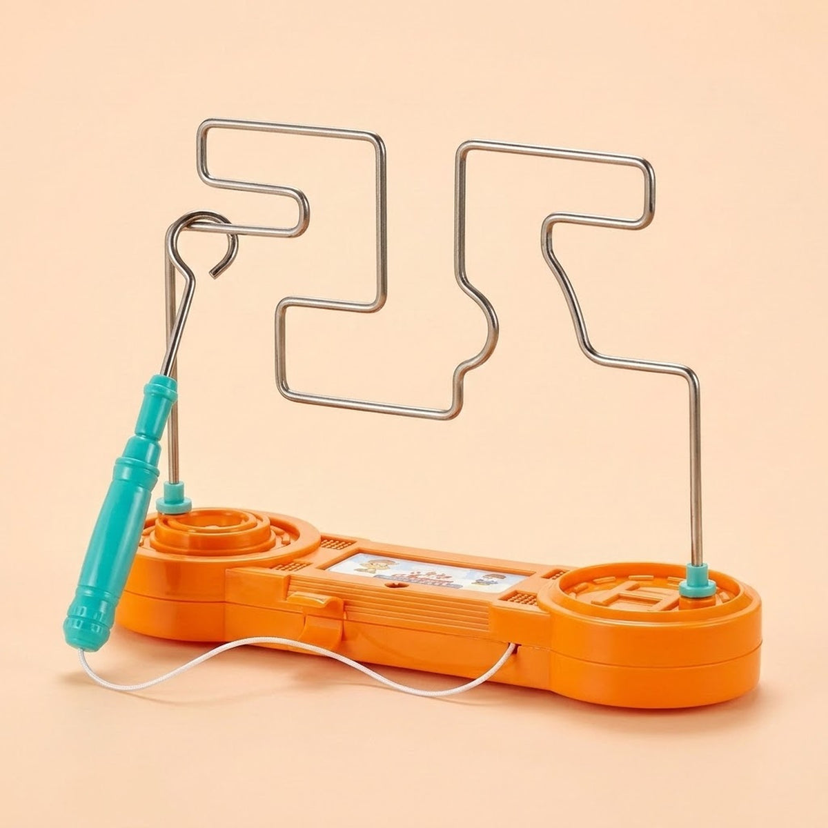 Orange plastic buzz wire game has a silver wire course, turquoise loop wand, and white cord against a peach background.
