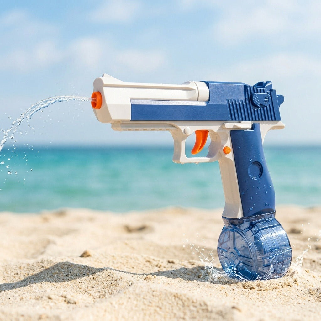 Blue-and-white plastic water gun with an orange trigger sprays water over sand against a turquoise sea and blue sky.