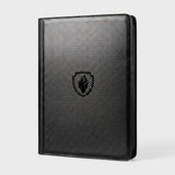 Upright black zippered trading card binder with a carbon fiber textured cover and flame emblem on a plain grey background.
