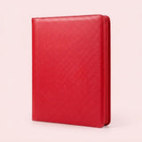 Upright red zippered trading card binder with a diagonally textured cover and stitched edges on a plain light background.