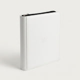 Upright white zippered trading card binder with a smooth cover and black zipper trim on a plain white background.