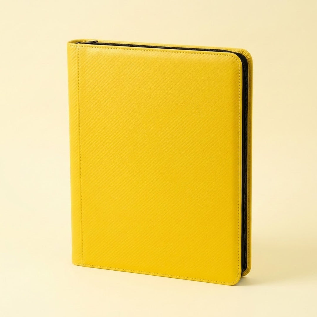Upright yellow zippered trading card binder with a smooth cover and black zipper trim on a plain cream background.