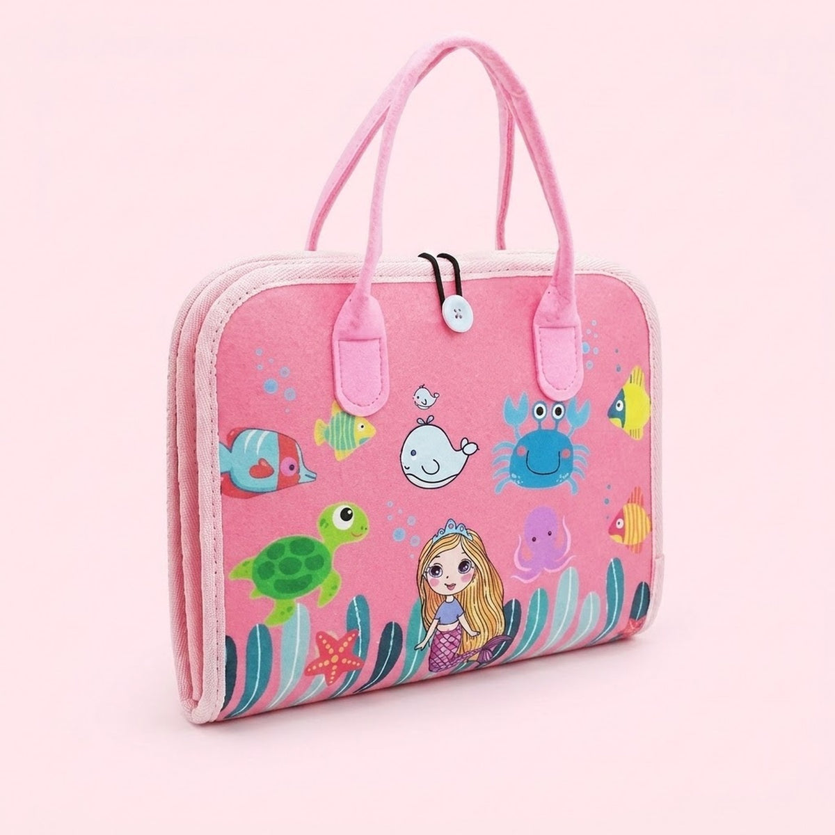 Closed pink felt busy board with carrying handles features a mermaid and colorful sea creatures against a pale pink background.