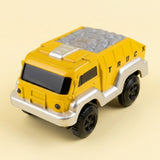 A yellow and silver toy dump truck with black wheels, shown on a solid pale beige background.