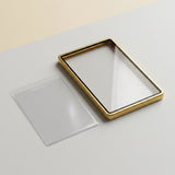 Gold aluminum alloy graded card protector lies flat beside a separate clear panel on a light gray surface.