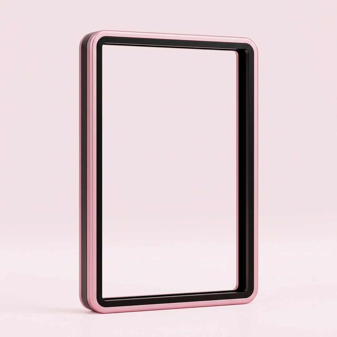 Pink aluminum alloy graded card protector with a black inner border and clear center stands upright against a pale pink background.