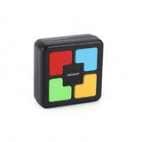 A square black plastic electronic memory game stands upright on a white background, showing red, blue, green, and yellow buttons.