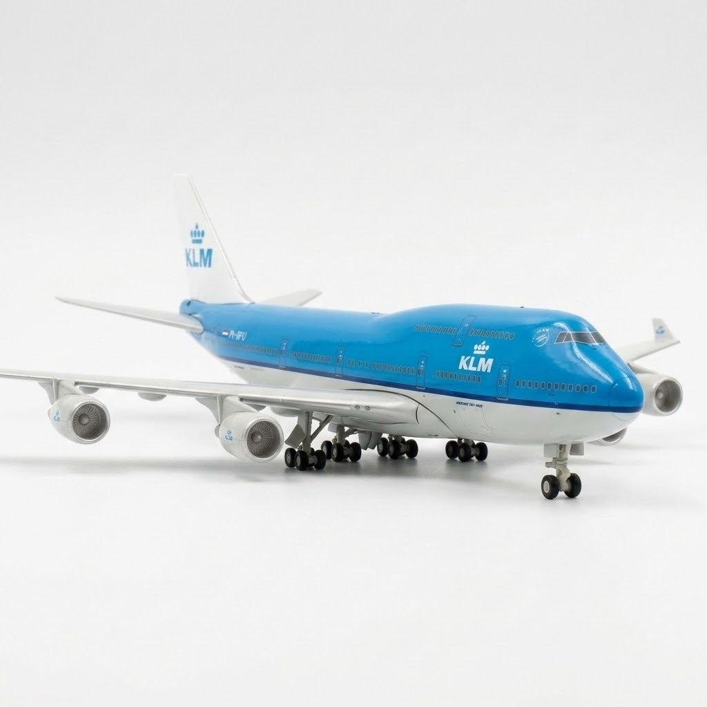 Diecast alloy aircraft model in blue and white with extended landing gear, photographed from a low front angle against a white background.