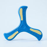 A blue three-blade EVA boomerang with pale yellow accents stands upright against a light blue studio background.