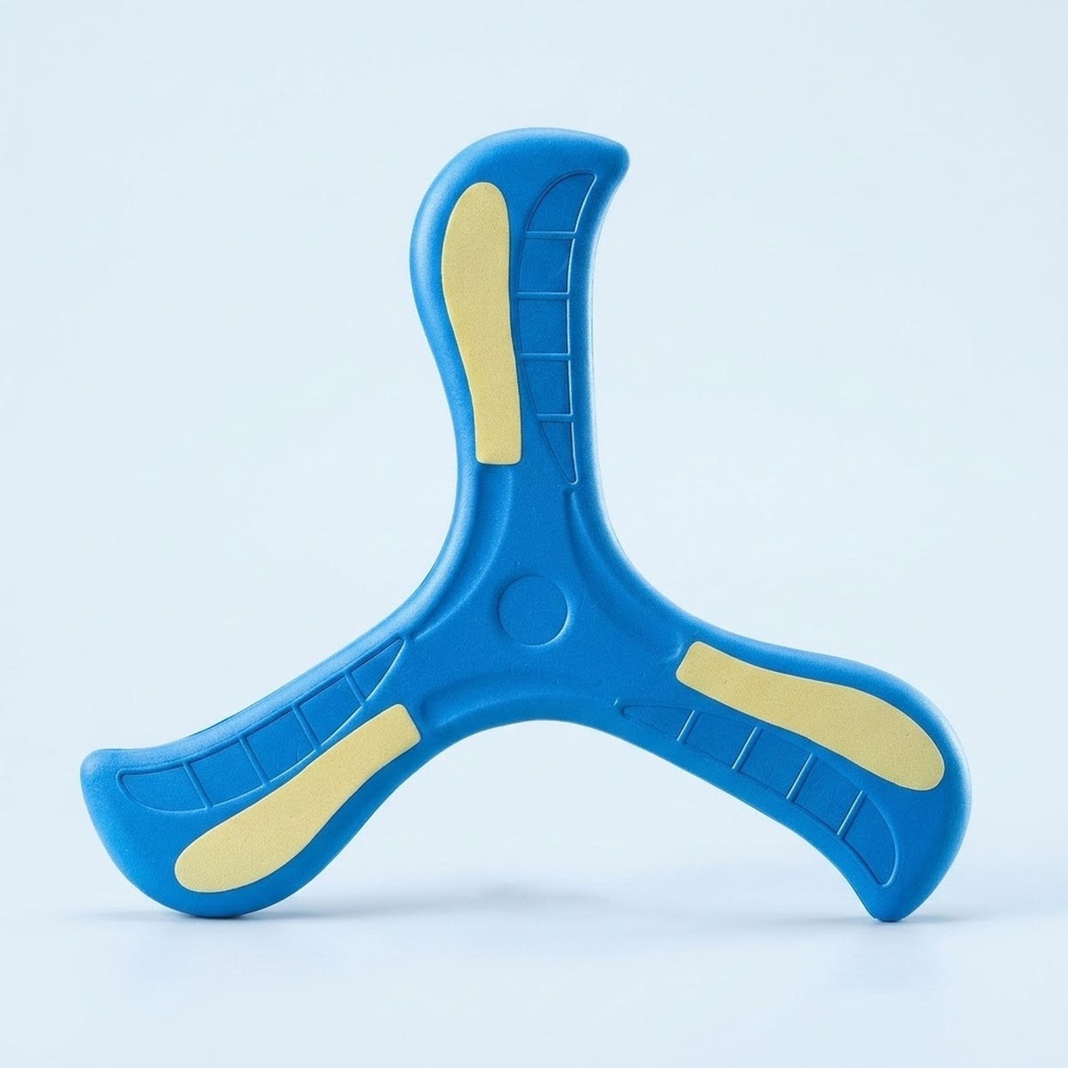A blue three-blade EVA boomerang with pale yellow accents stands upright against a light blue studio background.
