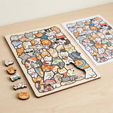 Partially assembled wooden cat jigsaw puzzle with loose cat-shaped pieces and a matching reference drawing on a light wood table.