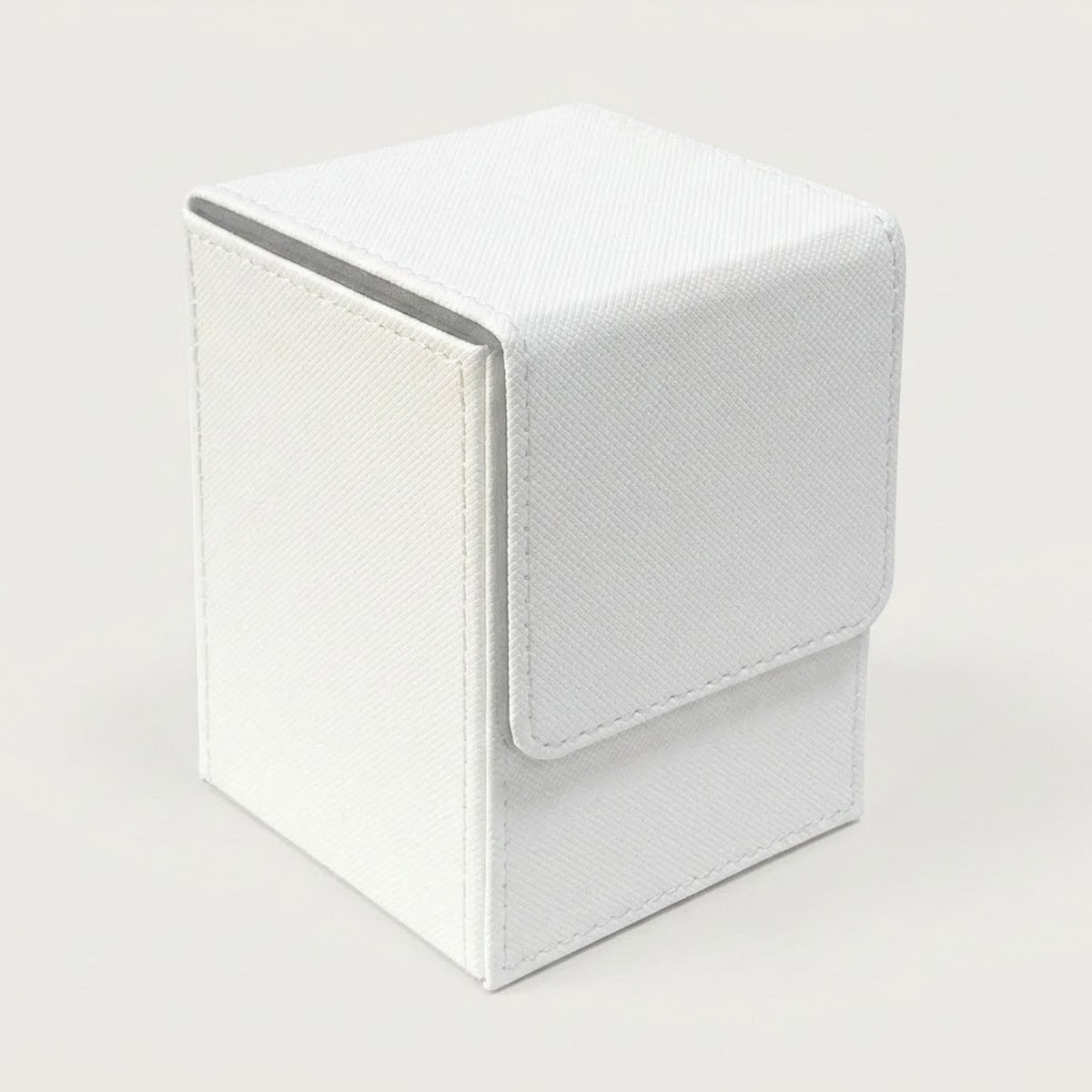A white textured deck box with visible stitching and a closed fold-over flap stands against a light gray background.