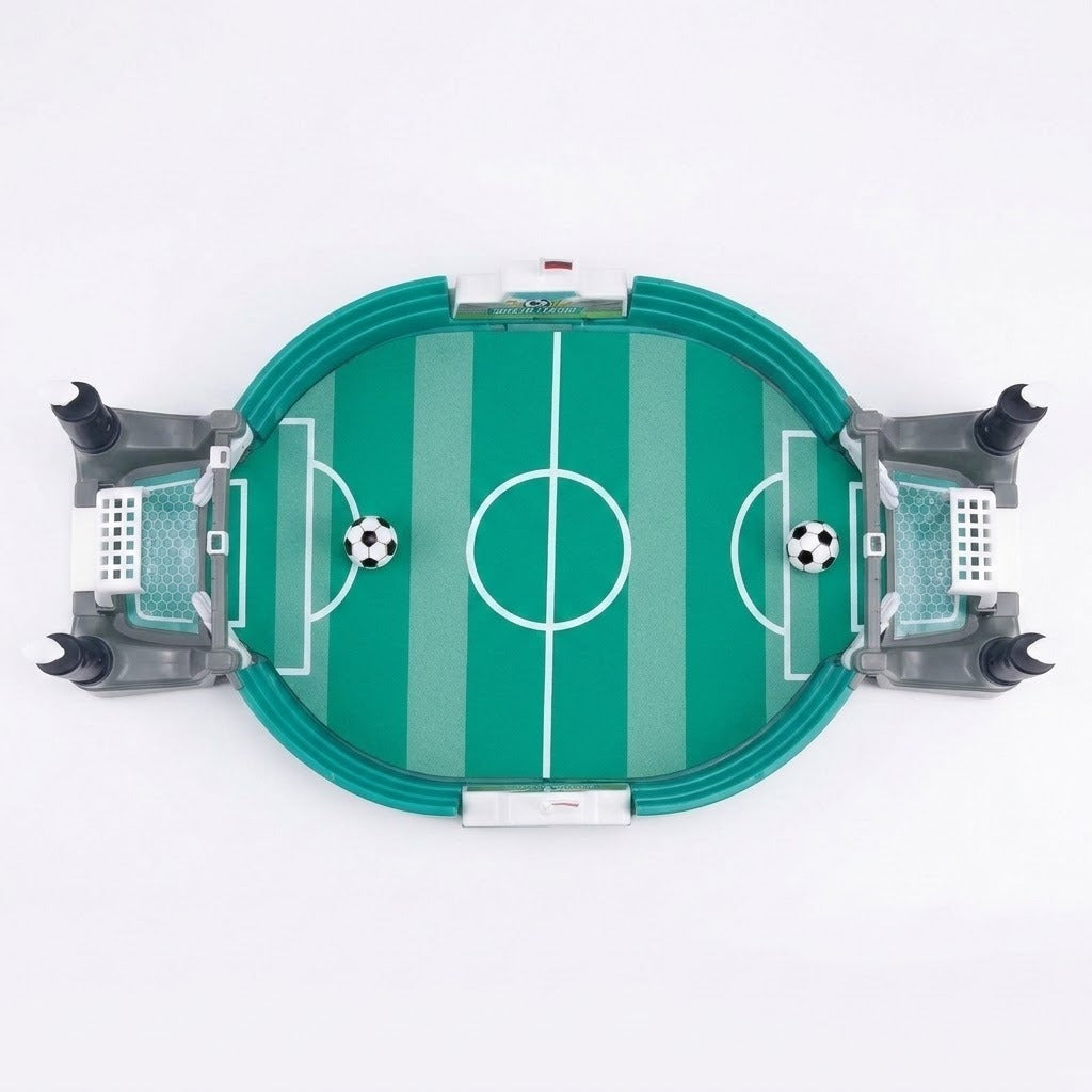 Green tabletop soccer game viewed from above with white field markings, gray goals, and two balls against a white background.